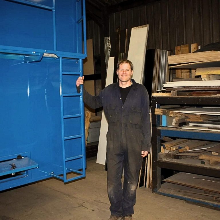 Man stood holding onto ladder